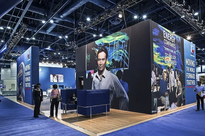 executive portrait displayed on oversized LED screen at corporate trade show booth