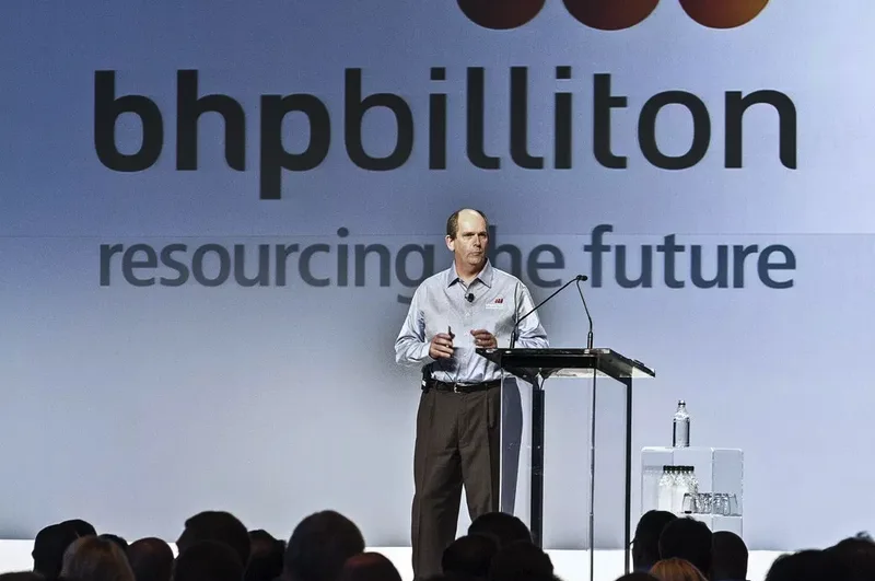 Business executive delivering keynote presentation at large corporate conference event